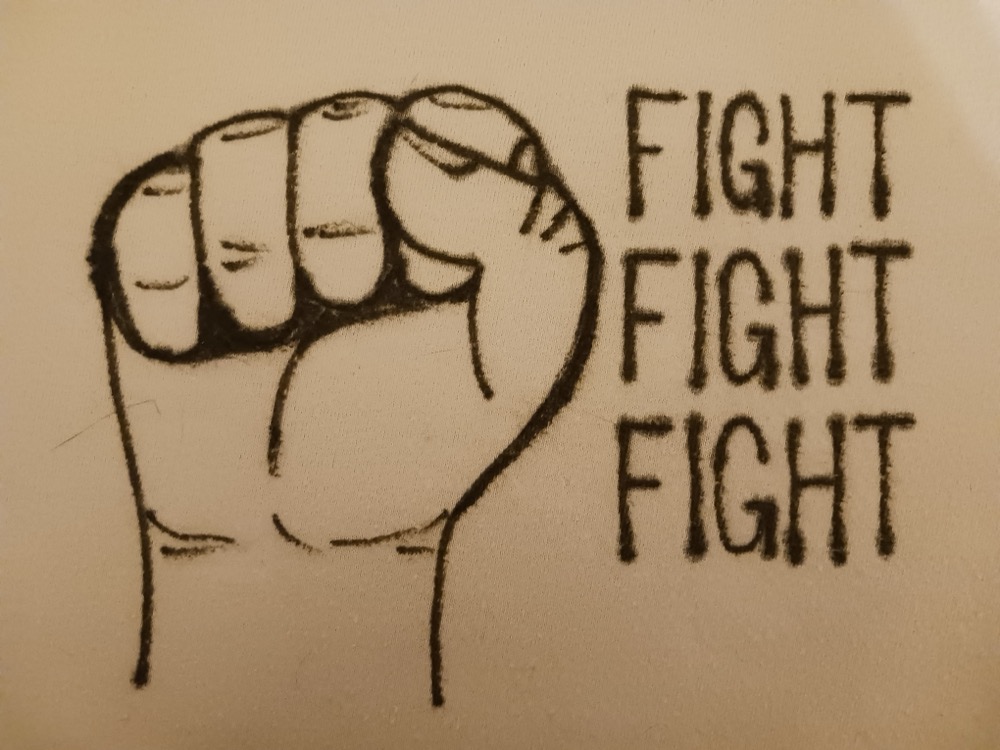 Hand-drawn raised fist beside the words FIGHT FIGHT FIGHT, printed on a classic light tee